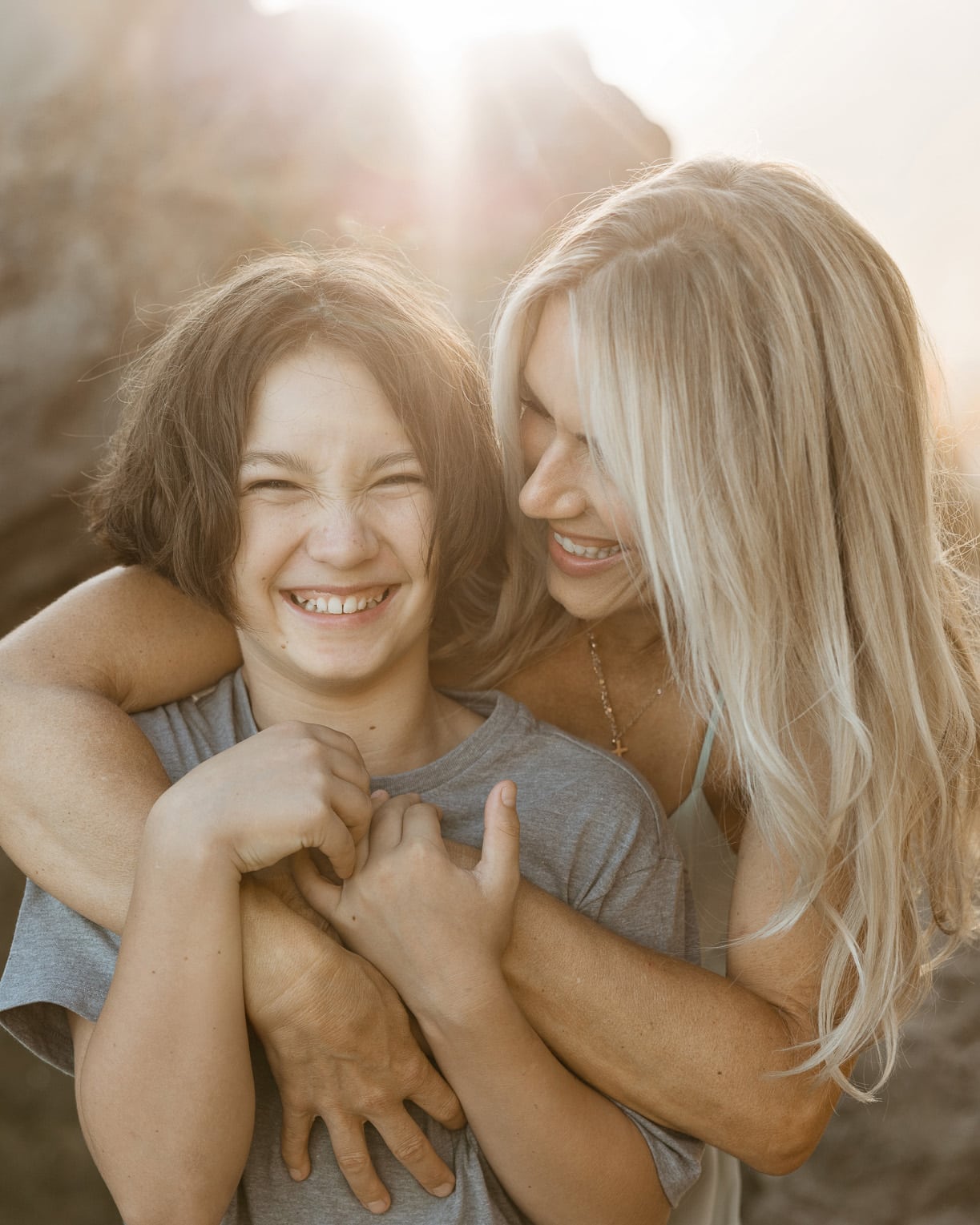 Mother hugging her pre-teen son during an effortless beach session at El Matador in Malibu.