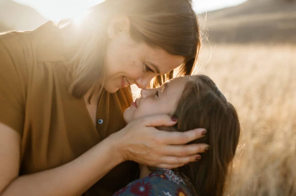 Mother and daughter sharing a quiet moment during a golden hour family photography session at Malibu Creek photographed by Erica Montgomery.