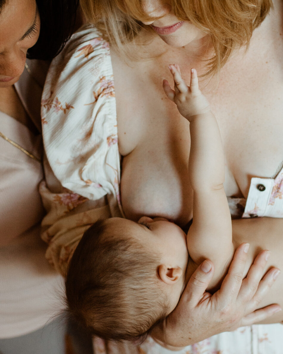 Mother breastfeeding her newborn baby during an in-home lifestyle newborn photography session in Los Angeles by photographer Erica Montgomery.