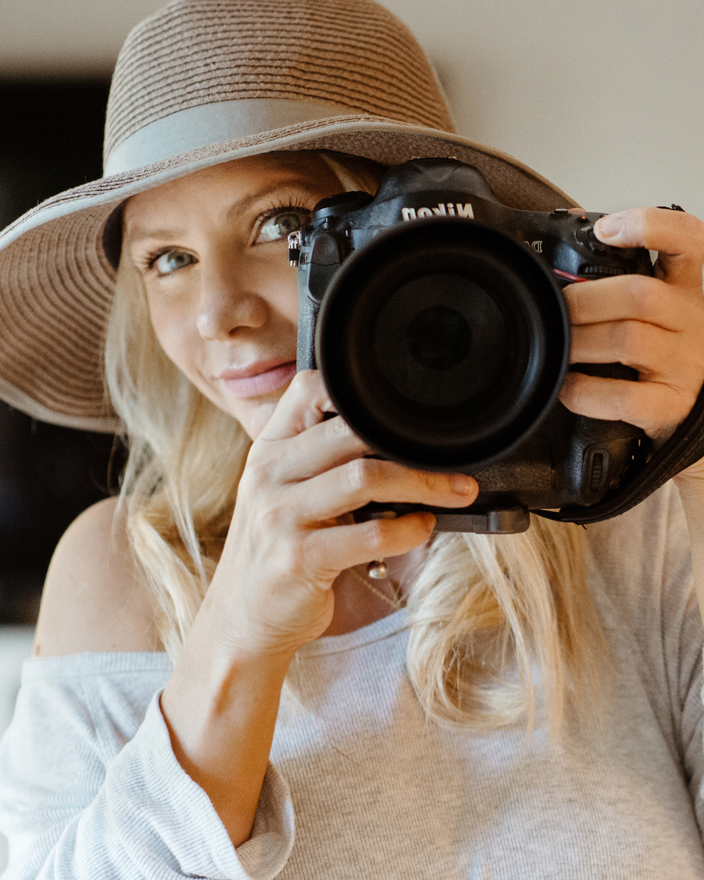 Malibu family and newborn photographer Erica Montgomery holding a Nikon camera during a portrait session.