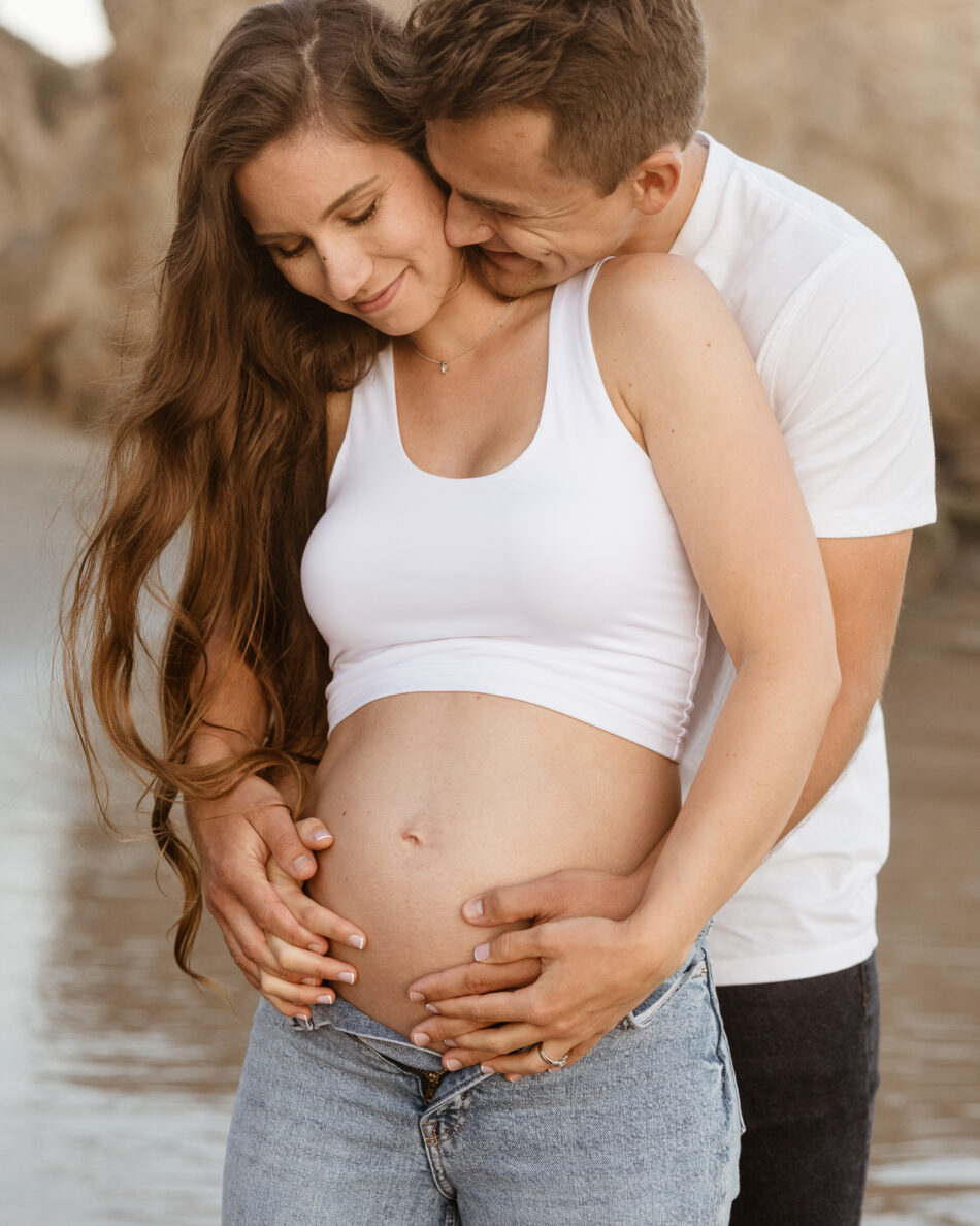 Sunset beach maternity photography session at El Matador State Beach in Malibu, showcasing a romantic couple style portrait by Erica Montgomery.