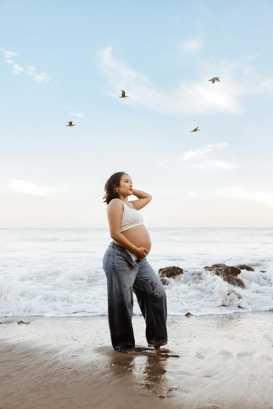 Editorial solo beach baby bump portrait at El Matador State Beach by Malibu maternity photographer Erica Montgomery.