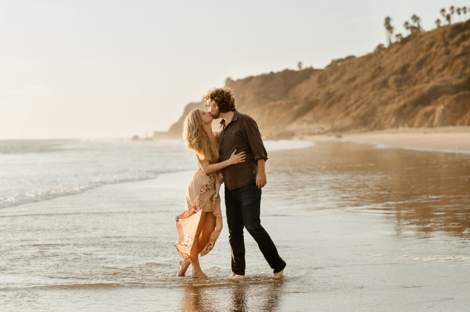 Man kissing his partner's forehead during a sun-drenched golden hour couples session in Calabasas by Erica Montgomery Photography.