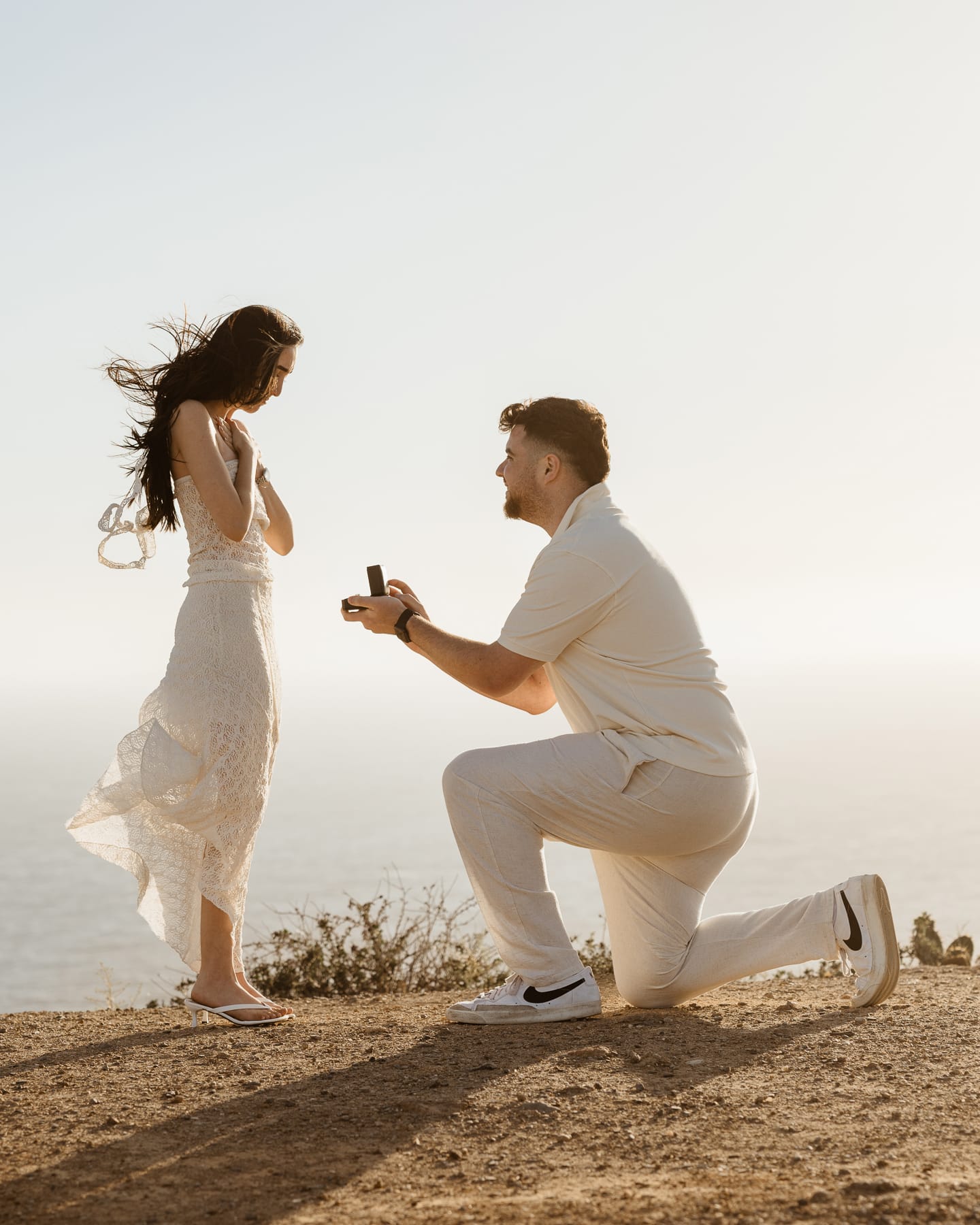 Surprise marriage proposal on the cliffs of Point Dume in Malibu at sunset.